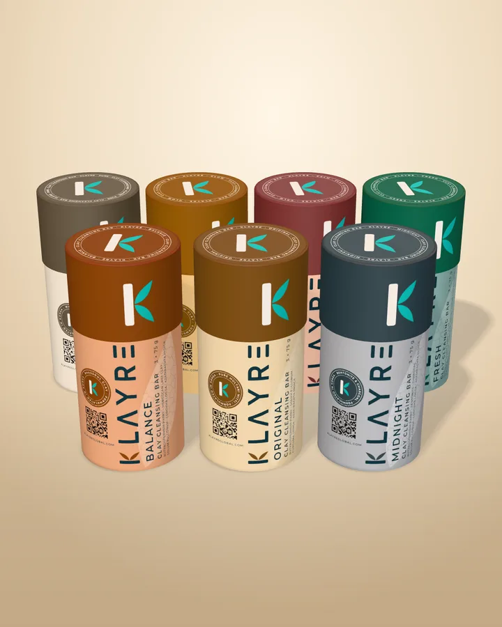 The seven Klayre clay bars in their paper tubes: Pure, Glow, Calm and Fresh behind Balance, Original and Midnight