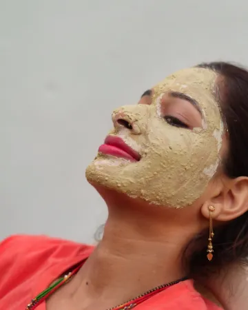 A woman resting with a clay mask on her face
